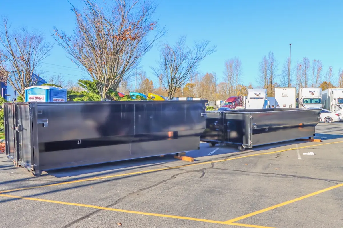 Professional dumpster rental service with roll-off container on residential driveway in Cherry Creek